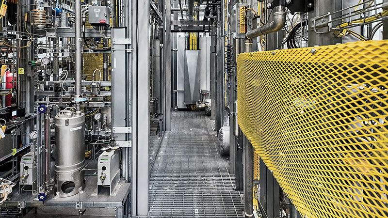 Industrial pipework, pressure gauges and valve manifolds inside a clean fuel electrochemical synthesis plant